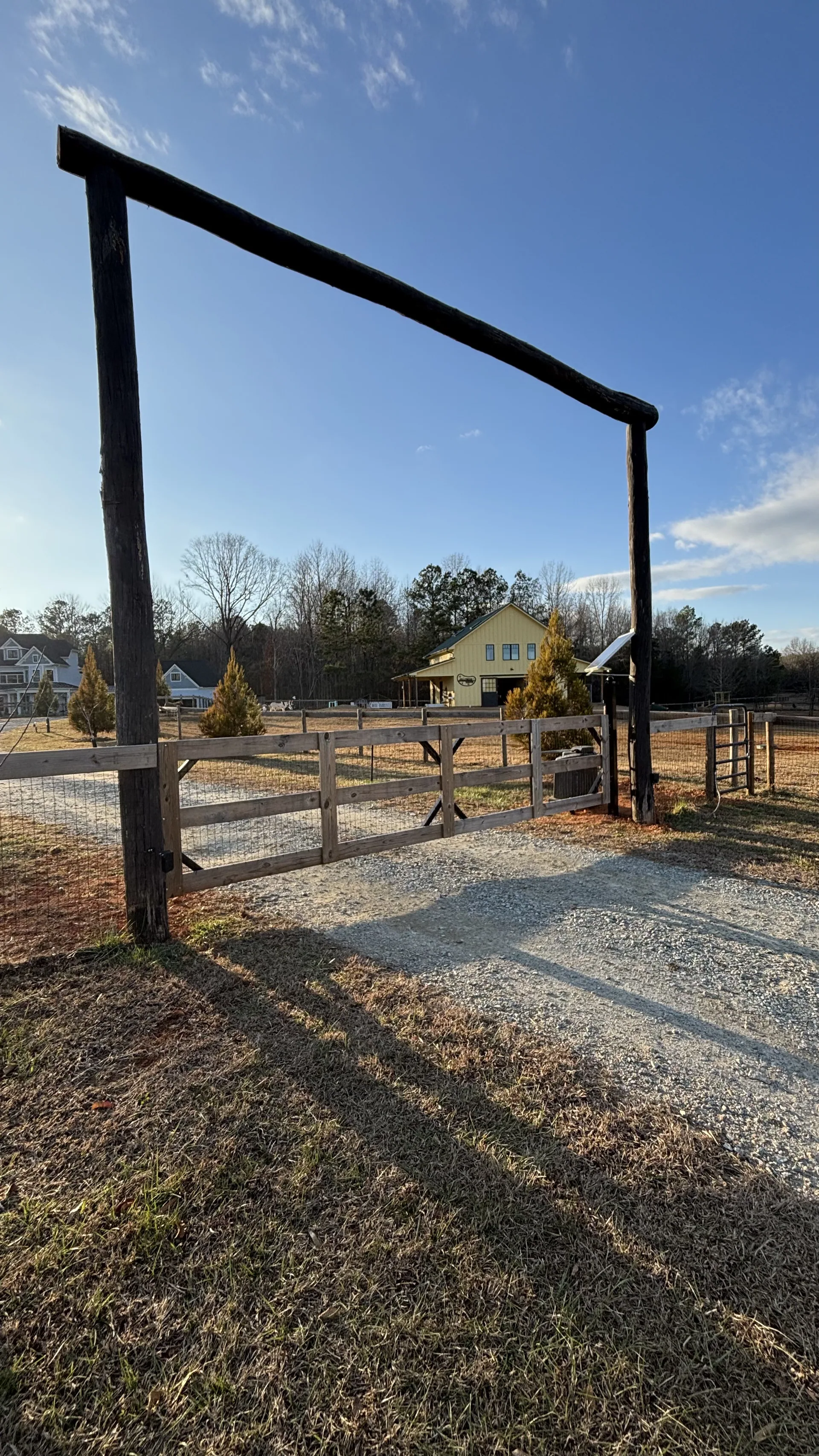 Wood farm gate at a driveway entrance on the edge of the Greensboro service area