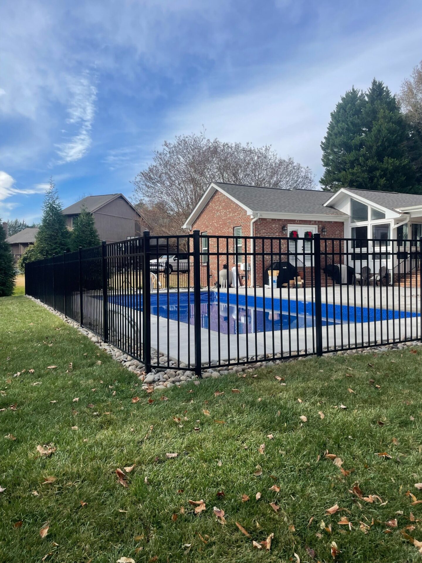 A black pool fence surrounds the pool.