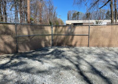 A chain link fence enclosing a yard, providing security and boundary to the outdoor space.